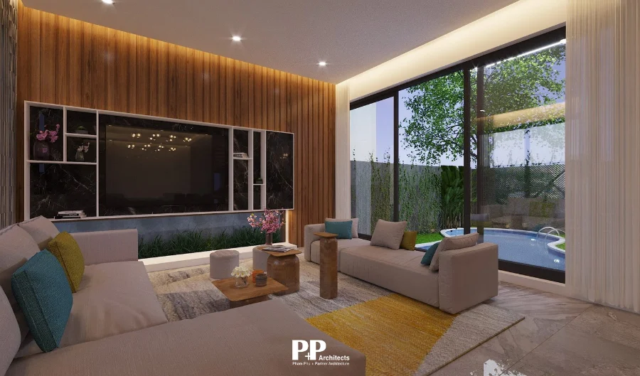 Phòng khách villa xanh Nha Trang kết nối sân vườn và hồ bơi qua cửa kính lớn